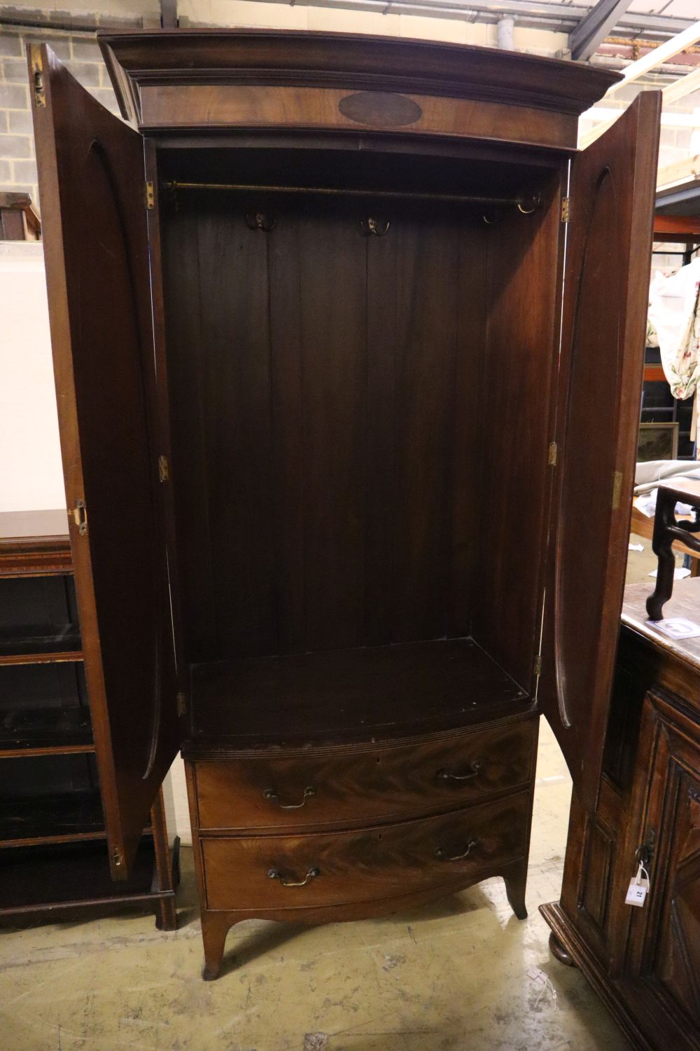 A 1920s George III style mahogany bow front wardrobe with two drawers, with key, width 102cm depth 54cm height 208cm